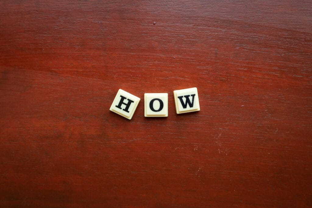 The word wow spelled with scrabble letters on a wooden surface