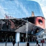 people walking near glass building during daytime